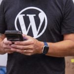 Person with WordPress shirt using a mobile device